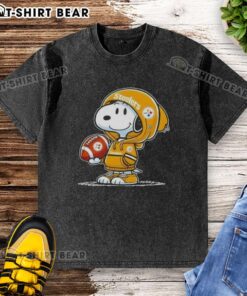 Alt Text: Snoopy in a hoodie smiles at fans, showcasing an Official Peanuts Pittsburgh Steelers washed t-shirt design.