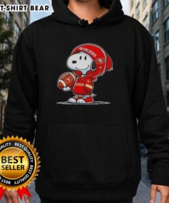 Snoopy in a San Francisco 49ers hoodie, smiling at fans at an event, showcasing Peanuts character charm.