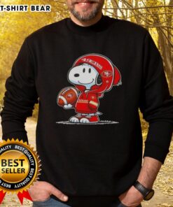 Alt Text: Snoopy in a hoodie smiling at fans, showcasing the Official Peanuts San Francisco 49ers sweatshirt.