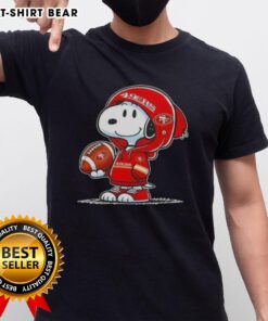 Alt Text: Snoopy in a hoodie supporting the San Francisco 49ers, smiling at fans on a vibrant T-shirt design.