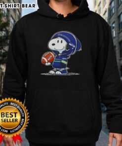 Snoopy wearing a Seattle Seahawks hoodie smiles at fans in this official Peanuts image, showcasing team spirit and fun.