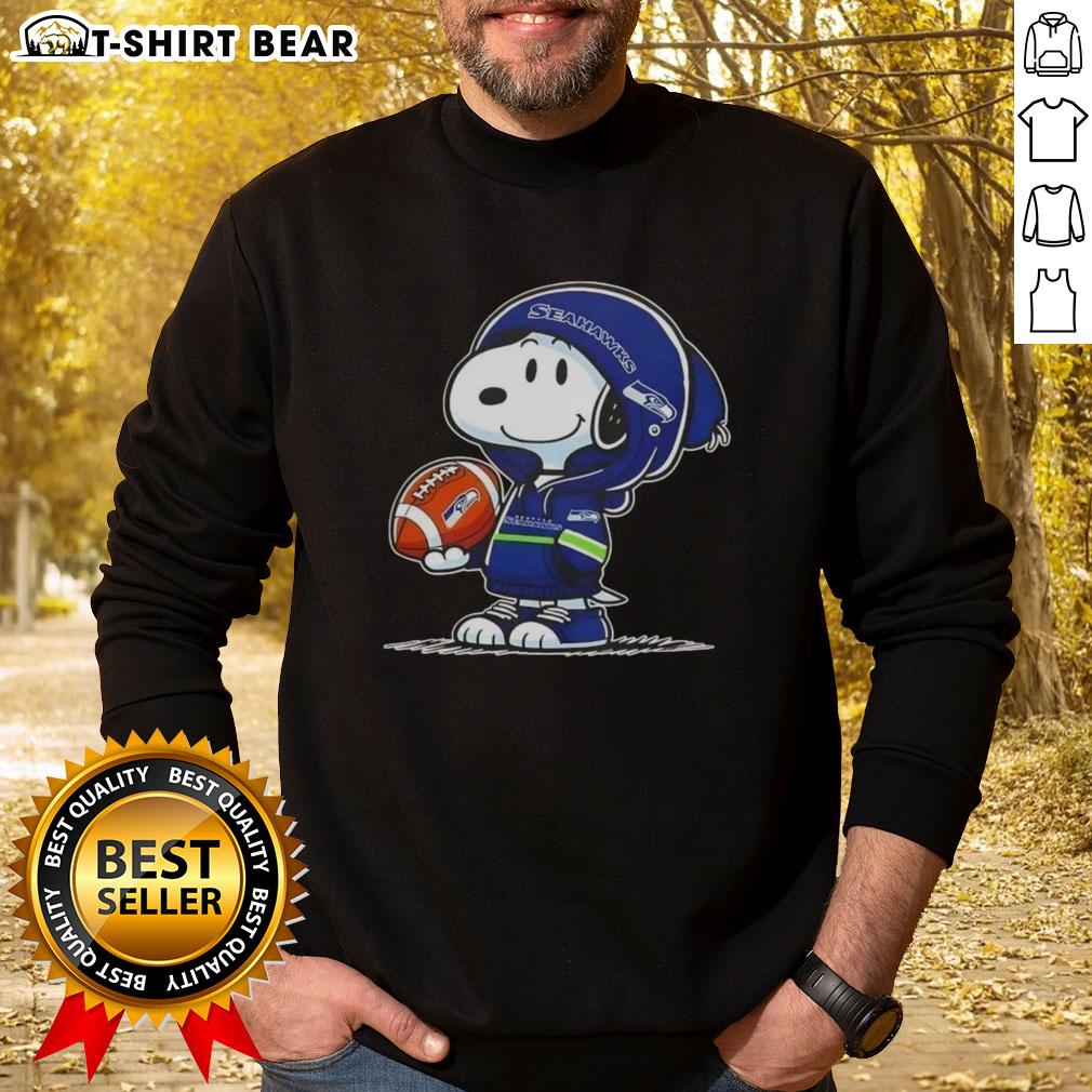 Official Peanuts Snoopy Wearing Hoodie Seattle Seahawks And Smilling At Fans Sweatshirt Snoopy in a Seahawks hoodie smiles at fans, showcasing the Official Peanuts sweatshirt design.