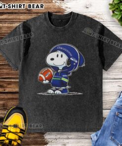 Snoopy in a Seattle Seahawks hoodie smiles at fans, featured on an Official Peanuts washed t-shirt.