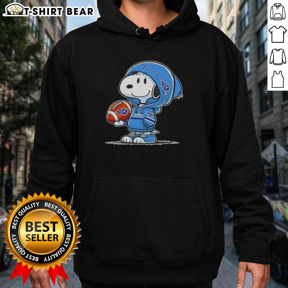 Official Peanuts Snoopy Wearing Hoodie Tennessee Titans And Smilling At Fans Hoodie Alt Text: Snoopy wearing a Tennessee Titans hoodie, smiling at fans, showcasing official Peanuts merchandise.