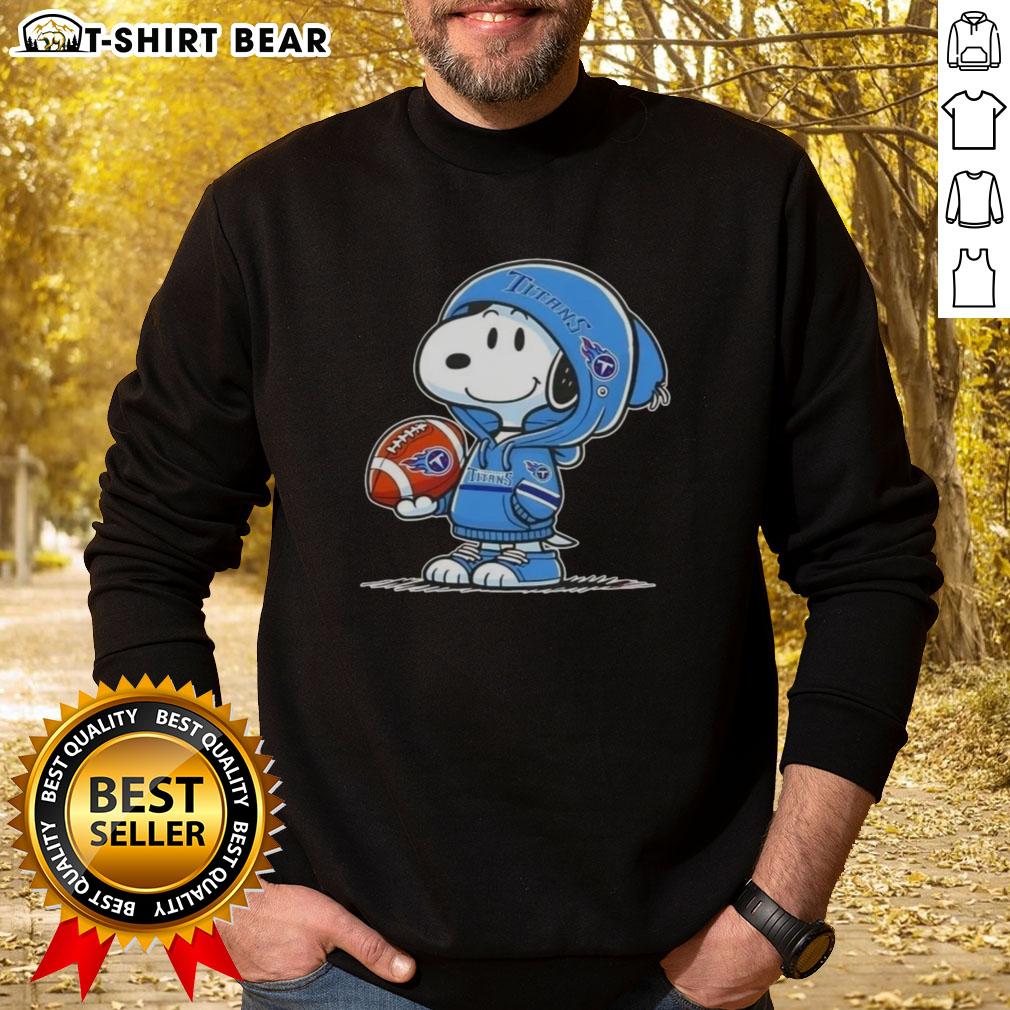 Official Peanuts Snoopy Wearing Hoodie Tennessee Titans And Smilling At Fans Sweatshirt Alt Text: Snoopy in a Tennessee Titans hoodie smiles at fans, showcasing the Official Peanuts sweatshirt design.