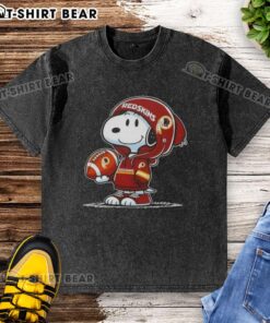 Alt Text: Snoopy in a Washington Commanders hoodie, smiling at fans, featured on a washed t-shirt design. Official Peanuts merchandise.