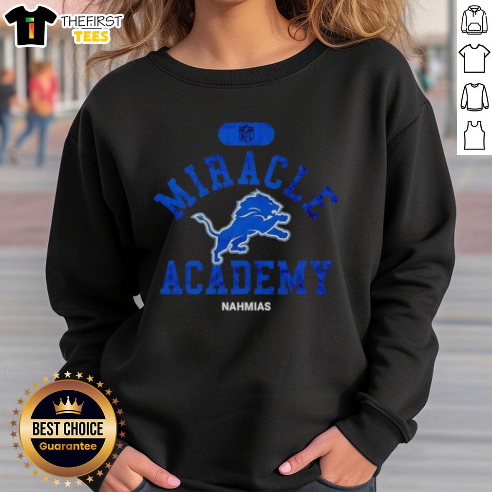 premium-nfl-detroit-lions-miracle-academy-nahmias-sweatshirt Alt Text: Premium NFL Detroit Lions Miracle Academy Nahmias Sweatshirt in blue with logo, perfect for fans and chilly days.