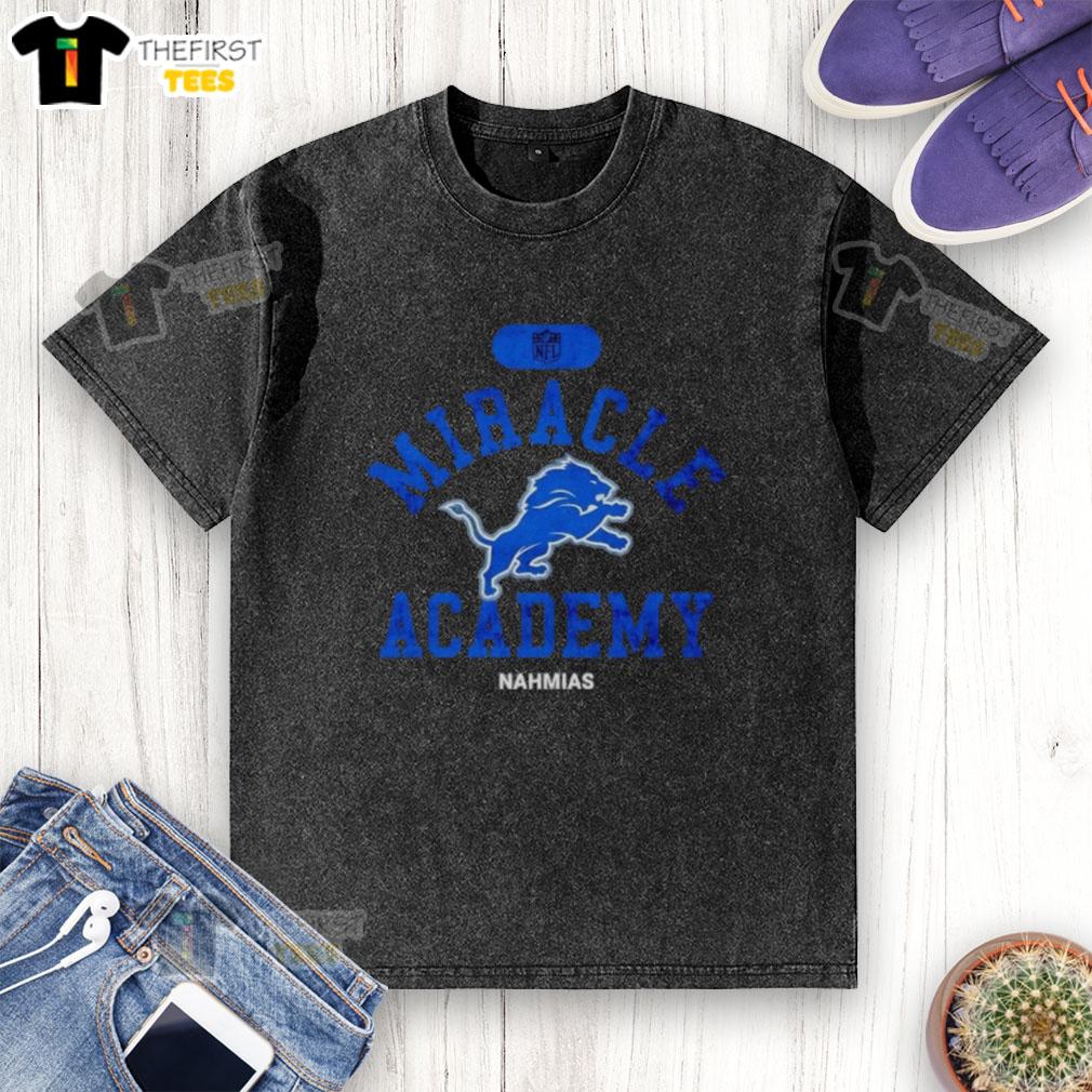 premium-nfl-detroit-lions-miracle-academy-nahmias-washed-t-shirt Alt Text: Premium NFL Detroit Lions Miracle Academy Nahmias washed t-shirt in blue, perfect for fans and casual wear.