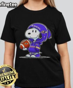 Premium Peanuts Snoopy in a Baltimore Ravens hoodie smiles at fans on a ladies tee, showcasing fun NFL spirit.