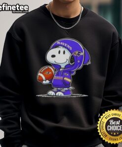 Alt Text: Premium peanuts Snoopy in a Baltimore Ravens hoodie, smiling at fans while wearing a cozy sweatshirt.