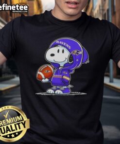 Premium Peanuts Snoopy in a hoodie smiling at fans, showcasing Baltimore Ravens spirit on a fun t-shirt design.