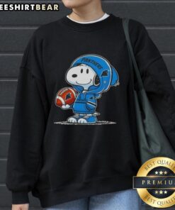 Alt Text: Premium Peanuts Snoopy in a hoodie, smiling at fans in a Carolina Panthers sweatshirt, perfect for sports lovers.