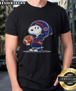 Alt Text: Premium Peanuts Snoopy in a hoodie smiling at fans on a Chicago Bears T-shirt, perfect for football enthusiasts.