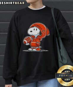 Alt Text: Snoopy in a hoodie smiling at fans, showcasing Premium Peanuts Cincinnati Bengals sweatshirt. Perfect for fans!