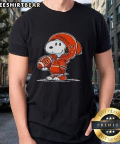 Alt Text: Premium Peanuts Snoopy wearing a Cincinnati Bengals hoodie, smiling at fans on a fun t-shirt design.