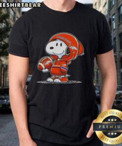 Alt Text: Premium Peanuts Snoopy in a Denver Broncos hoodie smiles at fans on a vibrant t-shirt design.