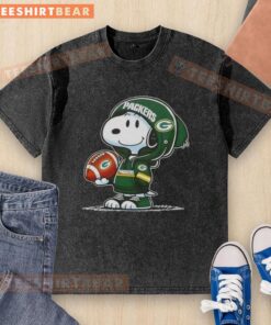 Alt Text: Snoopy in a Green Bay Packers hoodie smiles at fans, showcasing a premium peanuts washed t-shirt design.