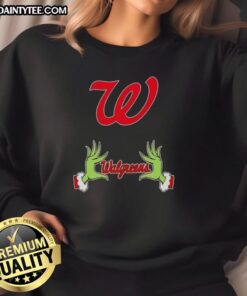 Premium Walgreens X Grinch Hands Merry Christmas Sweatshirt featuring festive design and cozy fit for holiday cheer.