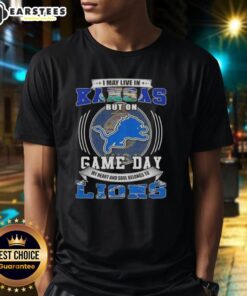 Alt Text: Pretty I May Live In Kansas But On Game Day Detroit Lions Football T-Shirt design featuring team colors and logo.