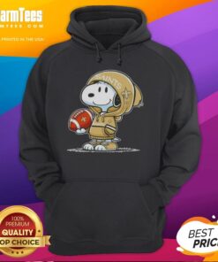 Snoopy wearing a New Orleans Saints hoodie smiles at fans, showcasing a fun and vibrant peanut character moment.