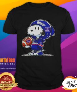 Cute Peanuts Snoopy in a New York Giants hoodie, smiling at fans on a fun t-shirt design.