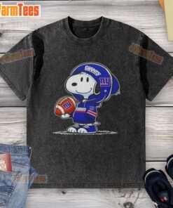 Alt Text: Snoopy wearing a New York Giants hoodie smiles at fans on a washed t-shirt featuring pretty peanuts design.