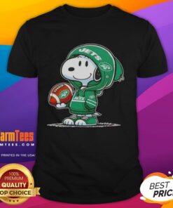 Alt Text: Snoopy in a hoodie, smiling at fans on a New York Jets T-shirt featuring Pretty Peanuts design.