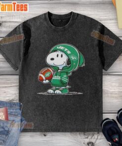 Snoopy wearing a New York Jets hoodie smiles at fans on a washed t-shirt featuring pretty peanuts design.