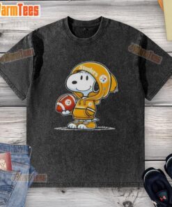 Snoopy in a hoodie smiles at fans, showcasing a 'Pretty Peanuts' washed t-shirt featuring the Pittsburgh Steelers.