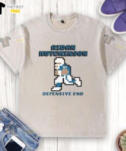 Alt Text: Aidan Hutchinson Detroit Lions Defensive End Pixel Washed T-Shirt featuring team colors and logo, perfect for fans.