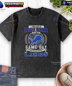 Washed T-shirt featuring 'I May Live In Indiana But On Game Day Detroit Lions Football' design for fans.