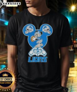 Top Mickey hands forming a heart on a Detroit Lions football t-shirt, perfect for fans showcasing team love.