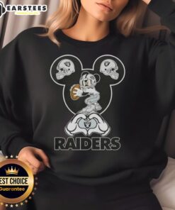 Alt Text: Top Mickey hands forming a heart on a Las Vegas Raiders football sweatshirt, showcasing team spirit and love.
