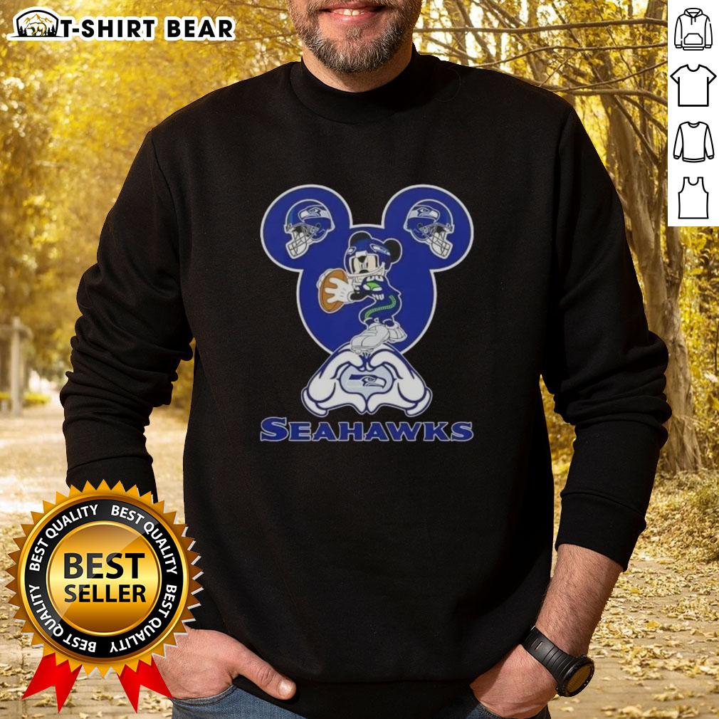 Top Mickey Hands Heart Love Seattle Seahawks Football Sweatshirt Seattle Seahawks sweatshirt featuring top Mickey hands forming a heart, perfect for fans showing love for football.