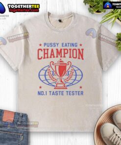 Alt Text: Top Pussy Eating Champion No. 1 Taste Tester trophy on a washed T-shirt, showcasing humor and unique design.