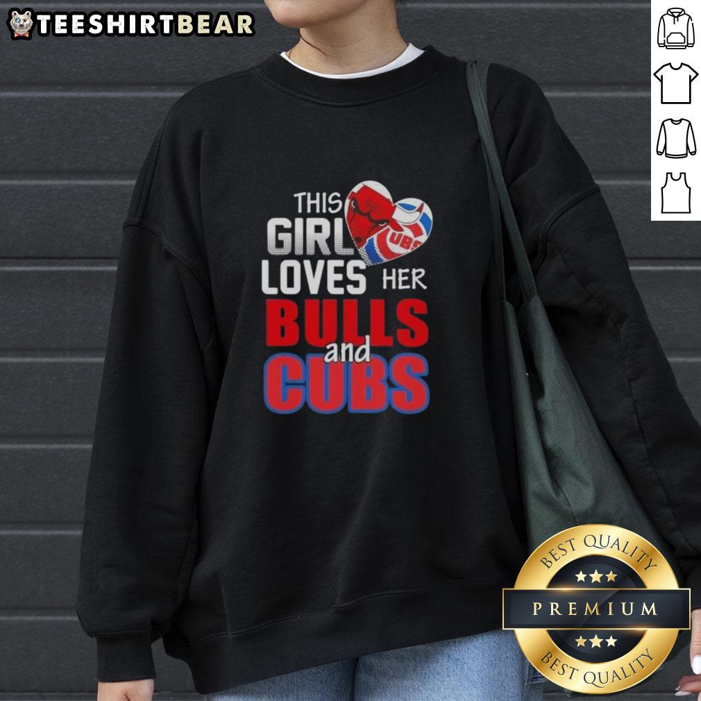 top-this-girl-loves-her-chicago-sports-bulls-and-cubs-sweatshirt Alt Text: Girl wearing a Chicago sports sweatshirt, showcasing love for Bulls and Cubs, smiling in a vibrant urban setting.