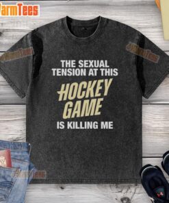 Premium 'The Sexual Tension at This Hockey Game Is Killing Me' washed t-shirt displayed on a hanger, showcasing its design.