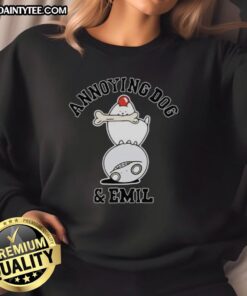 Emil wearing an Awesome Annoying Dog sweatshirt, smiling with a playful dog by his side in a cozy setting.