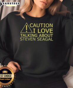 Awesome caution sweatshirt with 'I Love Talking About Steven Seagal' graphic, perfect for fans and casual wear.