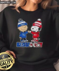 Alt Text: Awesome Charlie Brown fist bump with Snoopy on Kansas City sports sweatshirt for Royals and Chiefs fans.