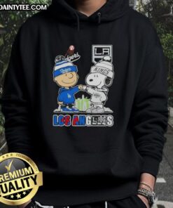 Alt Text: Awesome Charlie Brown fist bump with Snoopy, featuring Los Angeles skyline and Dodgers x Kings hoodie.