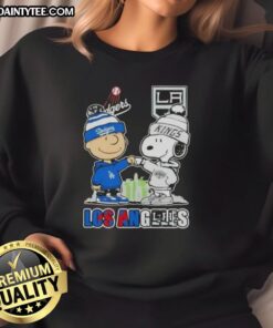 Awesome Charlie Brown fist bump with Snoopy, featuring Los Angeles skyline and Dodgers x Kings sweatshirt design.