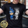 Awesome Charlie Brown fist bump with Snoopy on a Los Angeles Dodgers X Raiders T-shirt, perfect for sports fans.