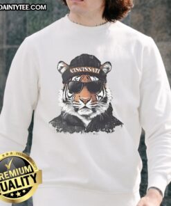 Cincinnati Bengals mascot in a beanie and sunglasses, showcasing team spirit in a cozy sweatshirt.