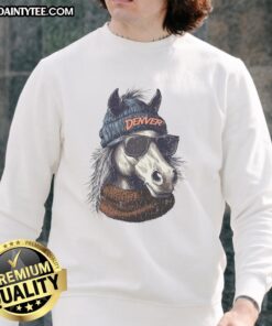 Denver Broncos mascot wearing a beanie and sunglasses, showcasing team spirit in a cozy sweatshirt.