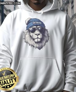 Awesome Detroit Lions mascot wearing a beanie and sunglasses, sporting a hoodie at a football game.
