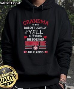 Awesome grandma in a cozy Alabama Crimson Tide hoodie, cheering enthusiastically during the game.