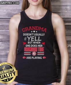 Awesome grandma in a tank top showing excitement while cheering for Alabama Crimson Tide during a game.