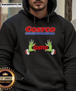 Awesome Grinch hands holding a Christmas hoodie from Costco Wholesale, perfect for festive holiday celebrations.