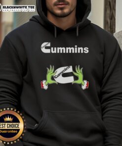 Awesome Grinch hands holding a Cummins Christmas hoodie, perfect for festive holiday style and automotive enthusiasts.